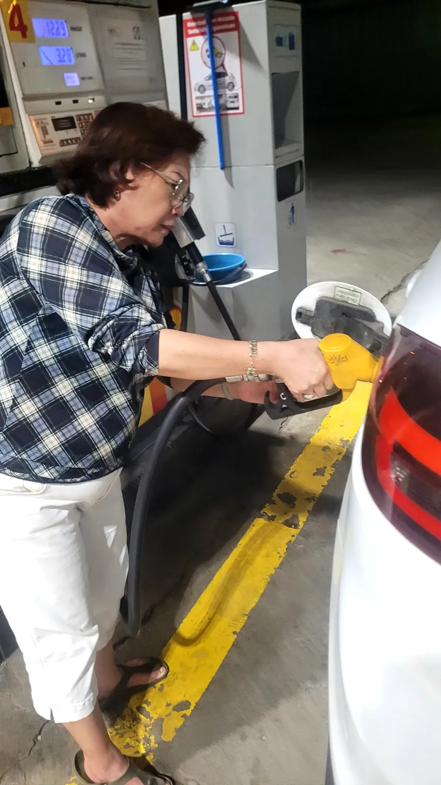 My mum at a petrol pump at night