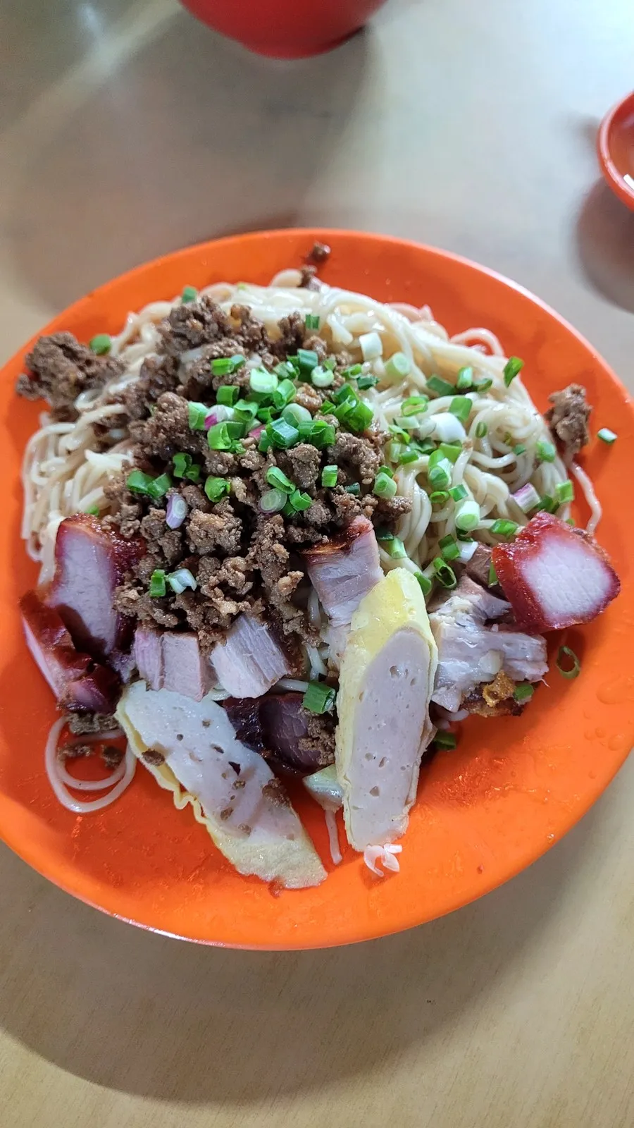 Noodles topped with minced meat and spring onion