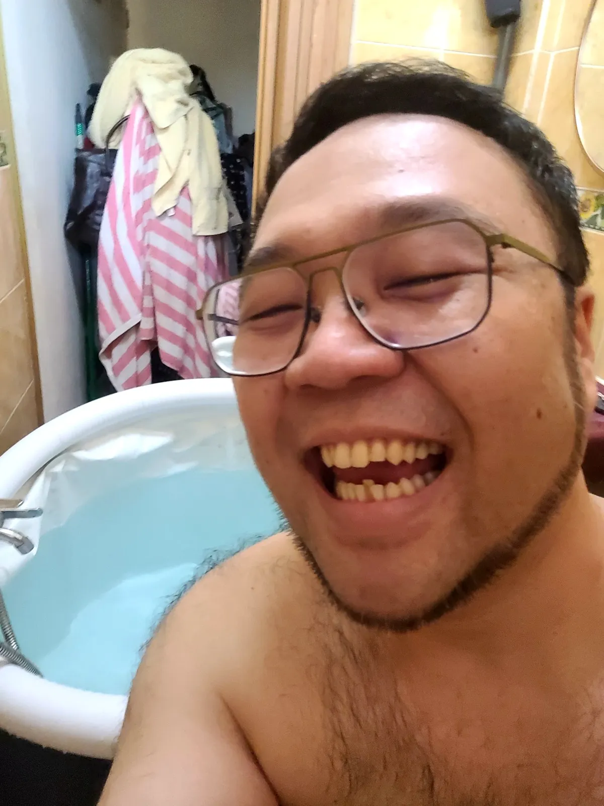 Me laughing in a small tub of water