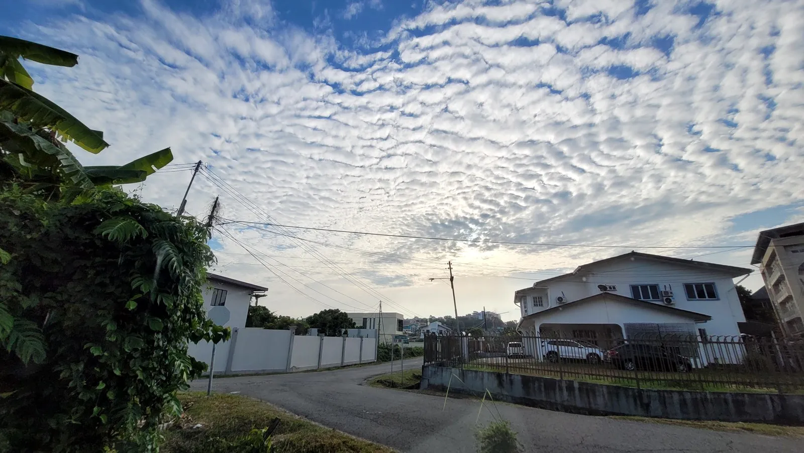 Rows of small clouds over the houses in the morning