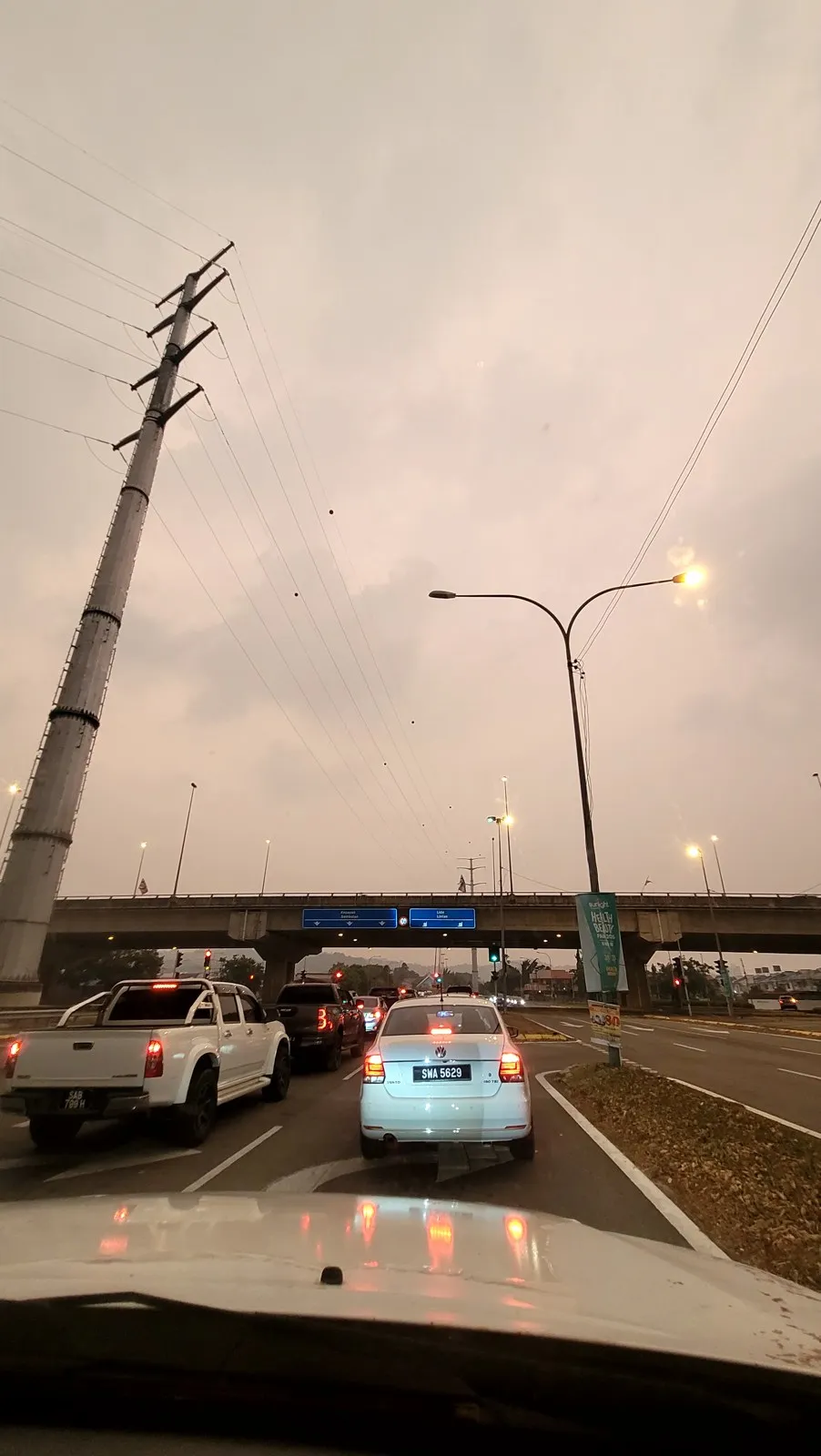 Evening traffic on the highway under a grey sky