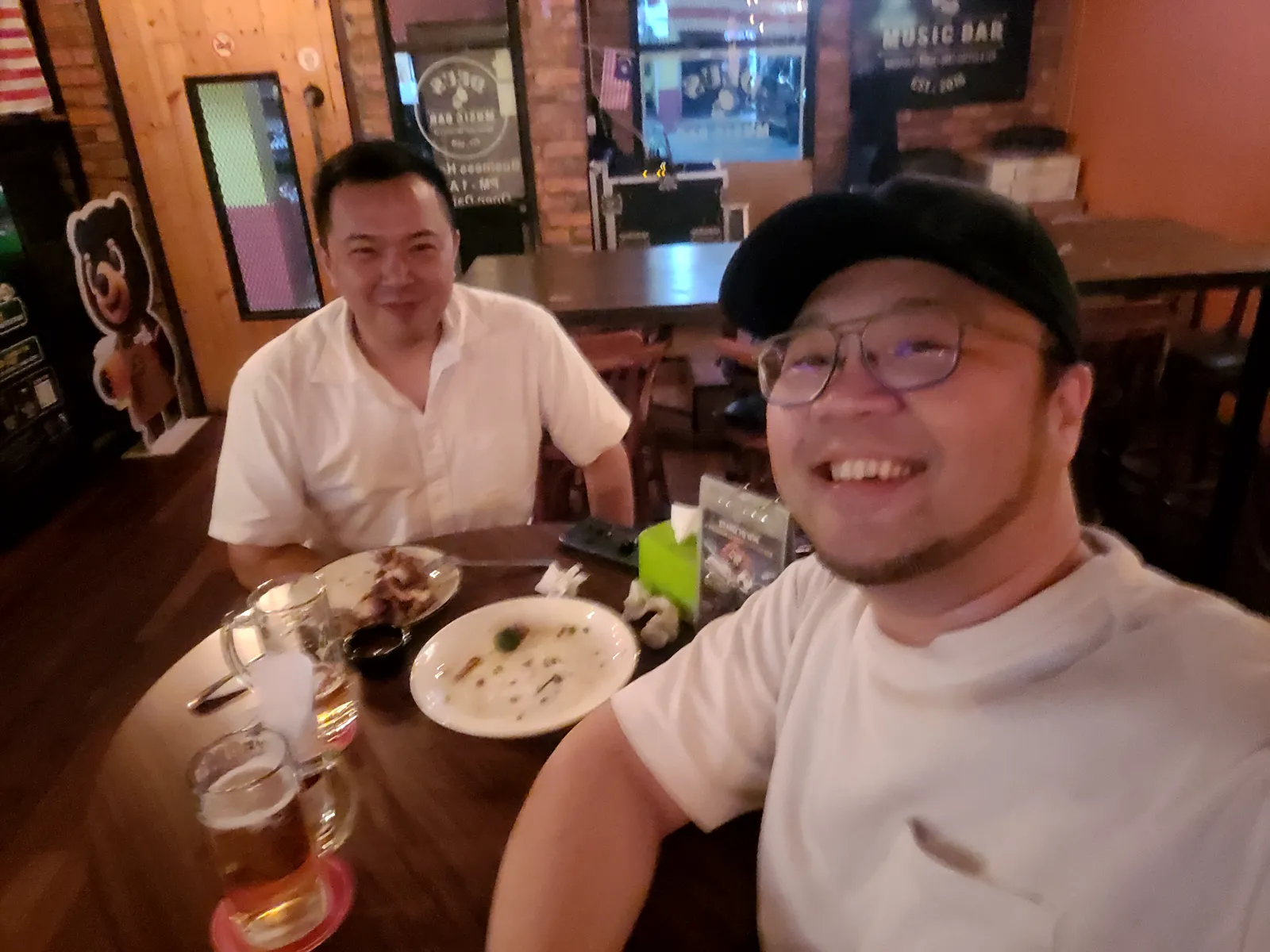 Selfie with a friend over dinner at a bar