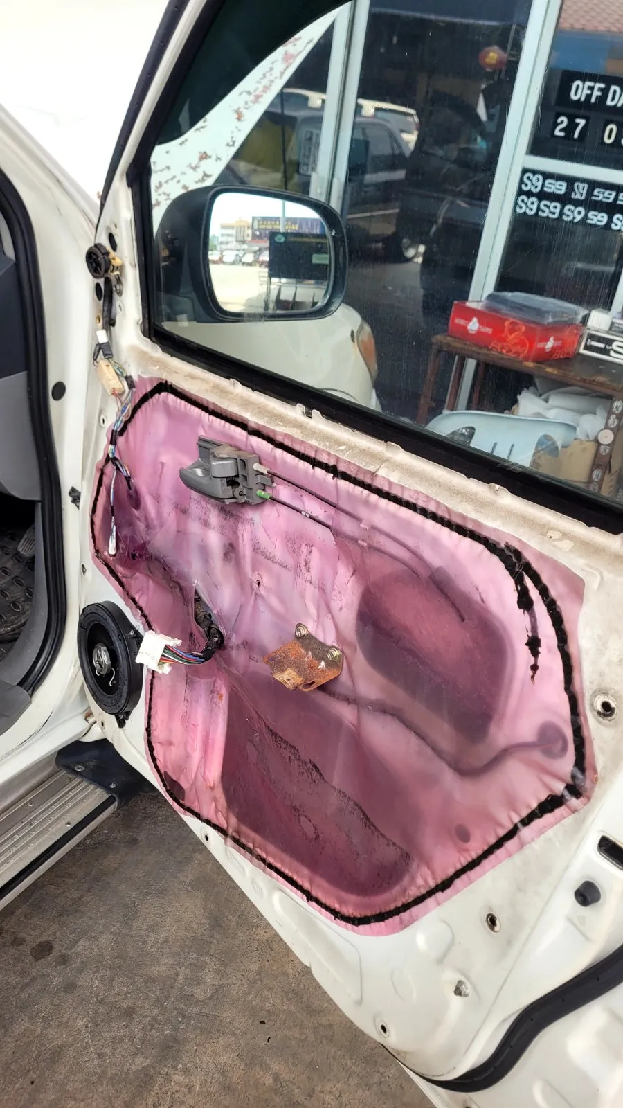 Truck door panel open with sound deadening and a new speaker